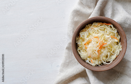 Photos Top view of bowl of sauerkraut with cabbage on towel