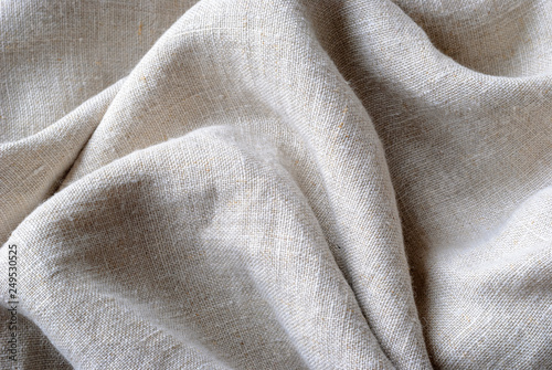 Gathered and folded texture of woven linen fabric photo