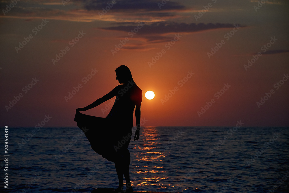 Woman watching sunset on the sea