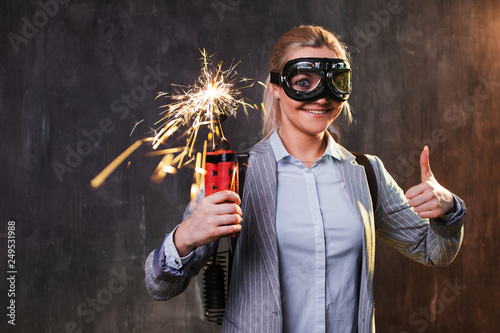 Schilderij op canvas Energetic young female leader with explosives and jetpack behind