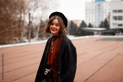 Stylish hipster girl in red sweater posing in the street © Vasya