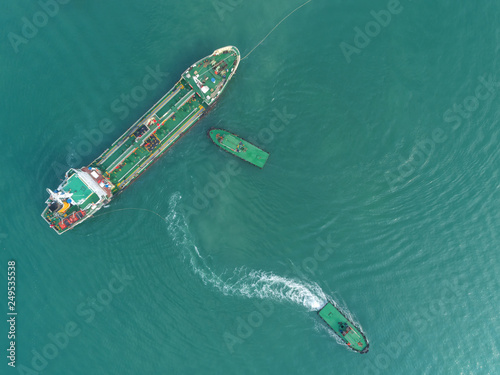 Aerial top view Tug boat drag Oil ship tanker for transport oil from refinery on the sea. © Pawinee