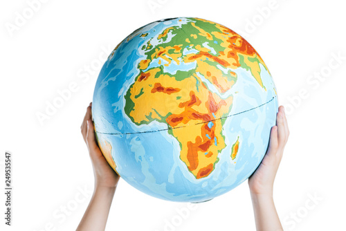 partial view of child holding globe in raised hands isolated on white  earth day concept