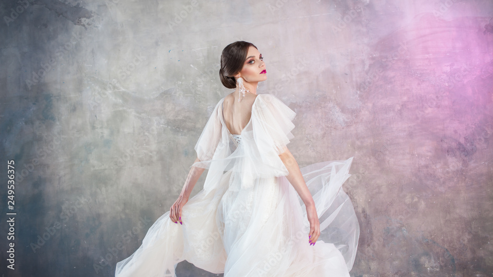 Beautiful and stylish bride in wedding dress with a lush flying skirt in Beautiful and stylish bride in wedding dress with a lush flying skirt in