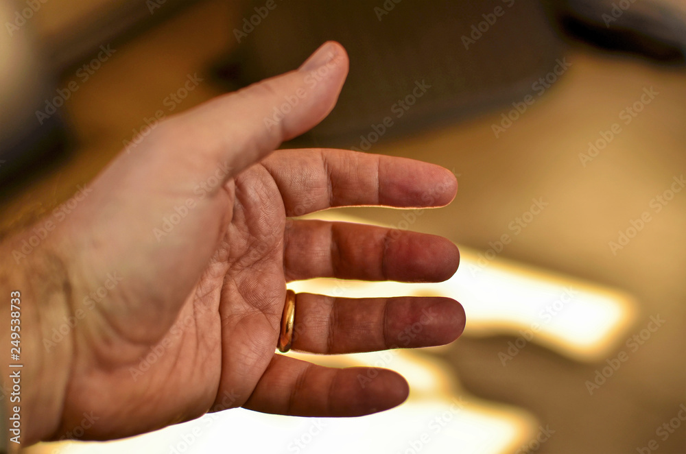 Male left hand of a caucasian man stretched forward.