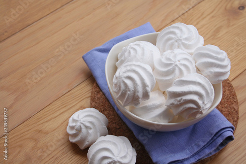 Wallpaper Mural Small white meringues in a bowl on wooden table Torontodigital.ca
