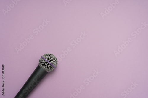 Vocal microphone in the left-down corner of purple background