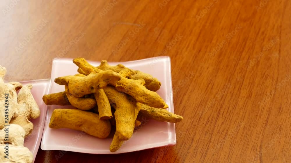 dry ginger on a white plate, turmeric pieces,dry ginger and turmeric pieces on white dish, dry ginger on a white plate, turmeric pieces,dry ginger and turmeric pieces on white dish,