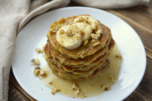 Stack of oatmeal pancake with banana, nuts and honey Healthy Breakfast	