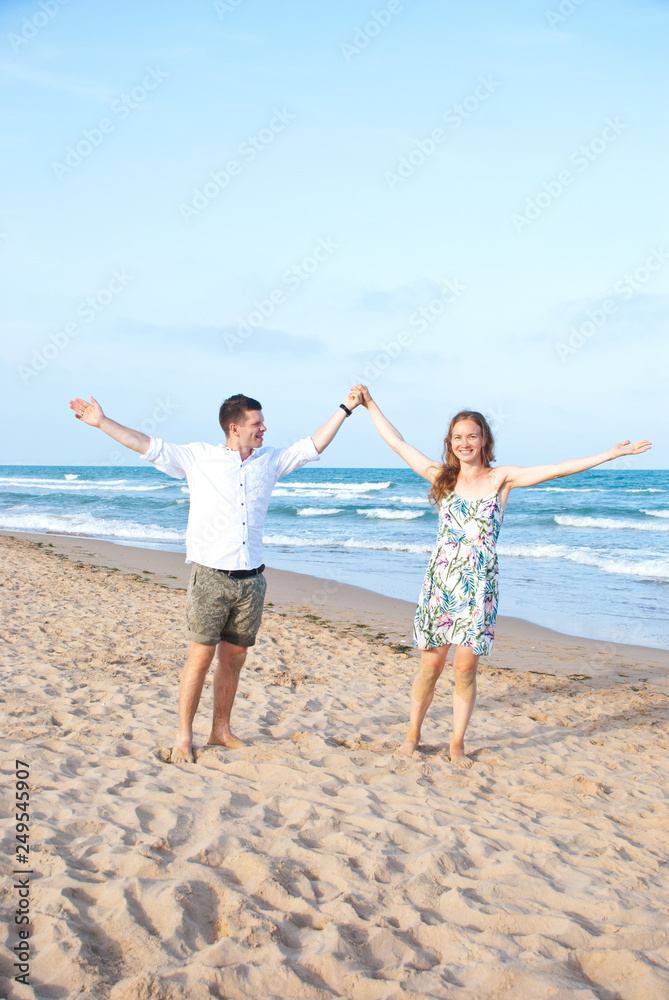 Happy couple of lovers on sea beach. Vacation with wife on ocean.