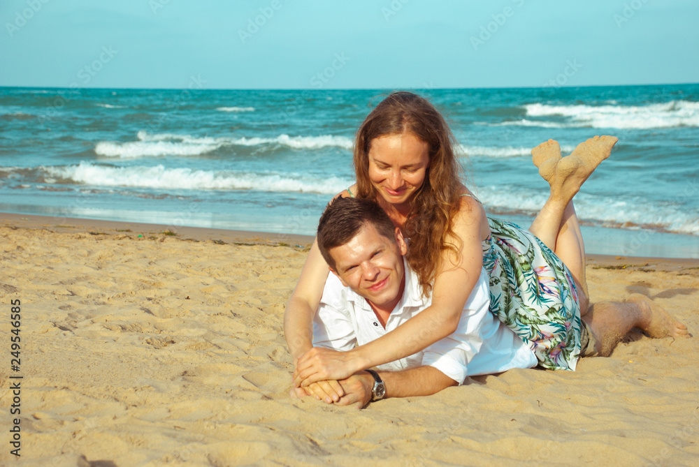 Couple of  lovers  on sea shore. Honeymoon vacation on the beach.