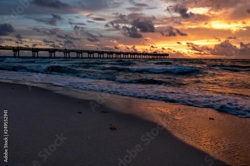 Fototapeta Naklejka Na Ścianę i Meble -  Bold Ocean Sunrise/Sunset with Pier