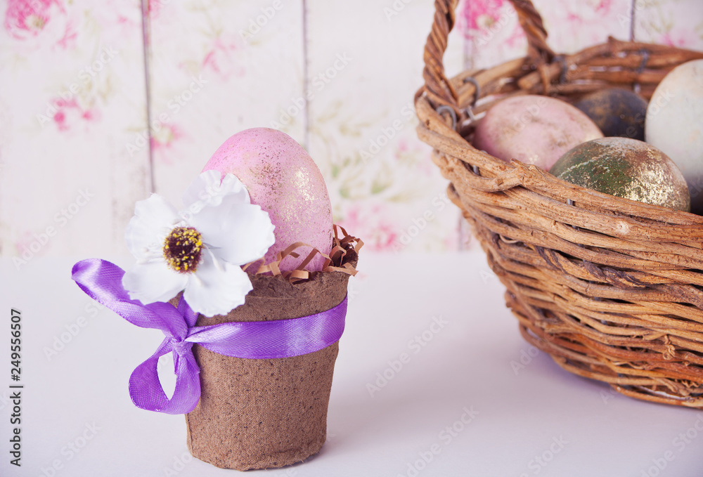 Easter pink egg in a pot on the table