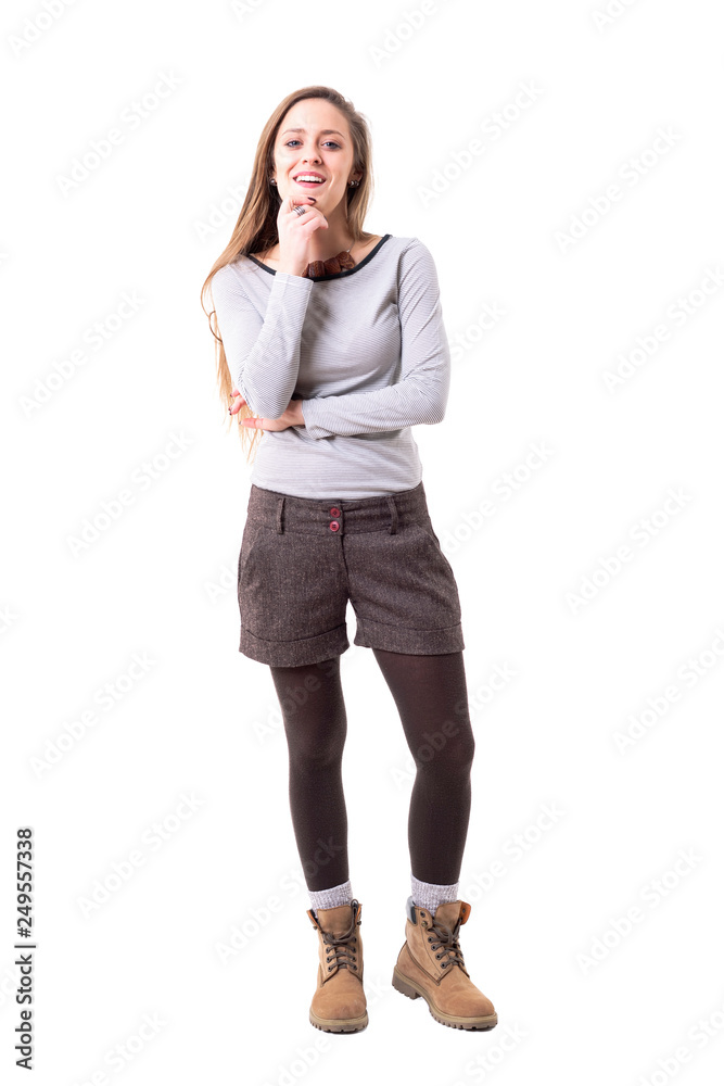 Satisfied young cute woman judging analyzing and smiling with approval and admiration looking at camera. Full body isolated on white background. Satisfied young cute woman judging analyzing and smiling with approval and admiration looking at camera. Full body isolated on white background.