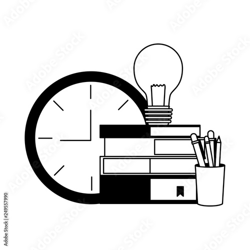 books stacked bulb clock and penclis photo