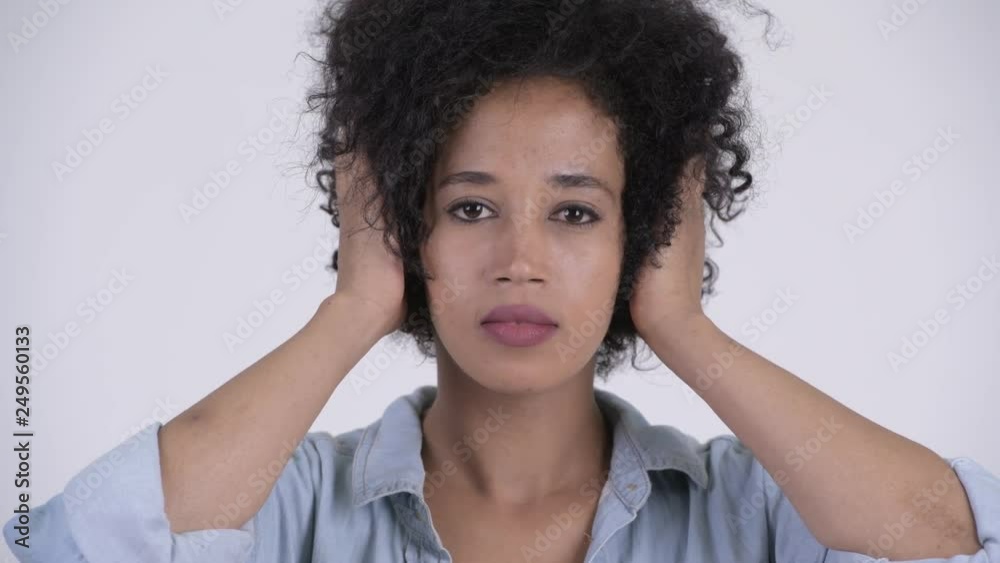 Face of young beautiful African woman covering ears as three wise monkeys concept Face of young beautiful African woman covering ears as three wise monkeys concept