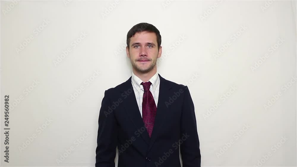 Young handsome businessman sneezes and covers his mouth with his hand. Portrait on white background Young handsome businessman sneezes and covers his mouth with his hand. Portrait on white background