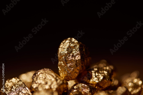 selective focus of golden stone isolated on black