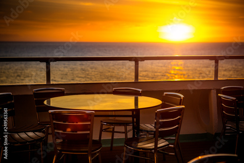 Cafe tables on balcony overlooking at sunset
