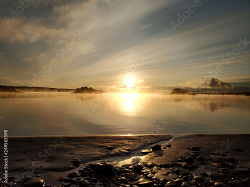 Autumn sunrise in the fog on the lake Yanisyarvi in Karelia