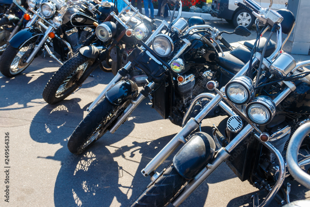 Row of motorcycles parked on city street Row of motorcycles parked on city street