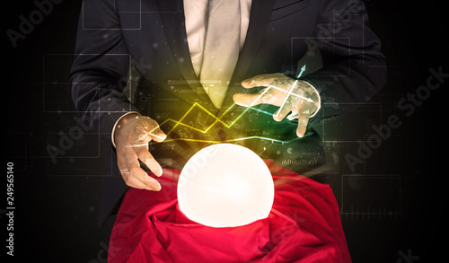 Fotografia Young businessman making predictions of the future of the stock market with a ma