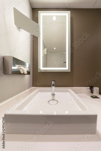 Interior of a modern hotel bathroom with a mirror