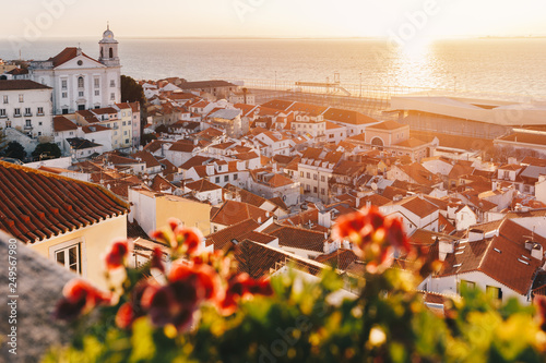 Sunrise Over Lisbon Old Town Alfama - Portugal. Lisbon Golden Hour Skyline. Balcony View on Alfama Old Town of Lisbon and Tagus River photo