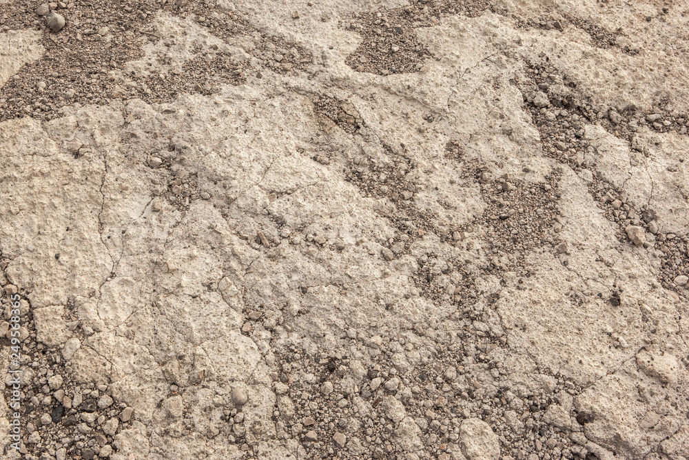Warm textured concrete wall with small stones as an abstract background Warm textured concrete wall with small stones as an abstract background