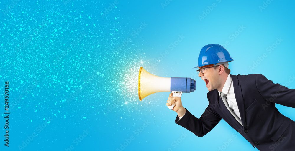 Fototapeta premium Young architect constructor yelling with megaphone and sparkling sounds 
