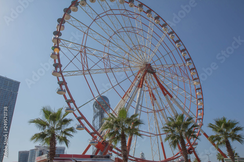 Ferris wheel on a bright sunny day in amusement park