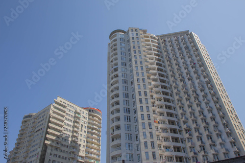 Modern apartment buildings exteriors in sunny day. Skyscraper in Downtown city