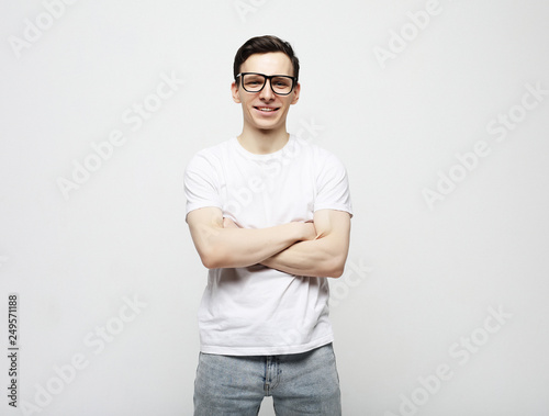 young man with emotions on his face a grey background