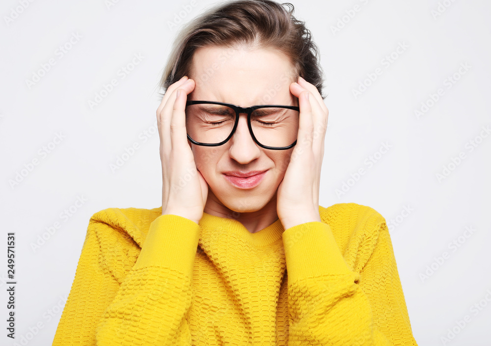 Handsome young man suffering from headache Handsome young man suffering from headache