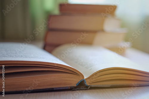 Close-up of open books on the table, selective focus and shallow depth of field