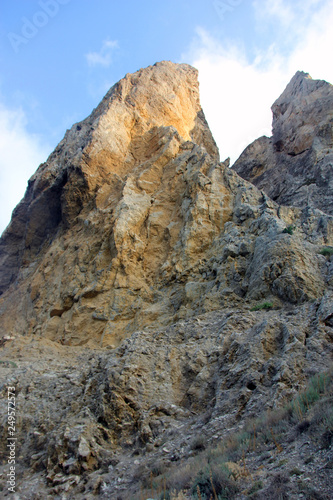 beautiful big high relief rocky stone cliff of sandy color on  blue sky background in crimea © c1a0