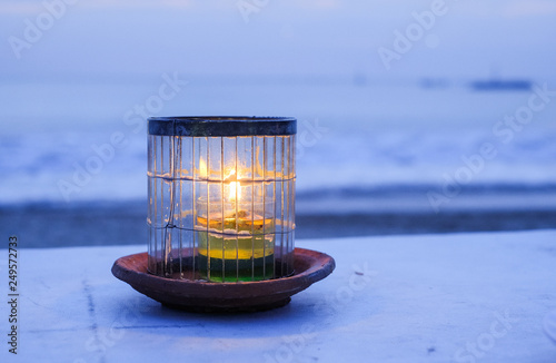 Candle on the background of the ocean