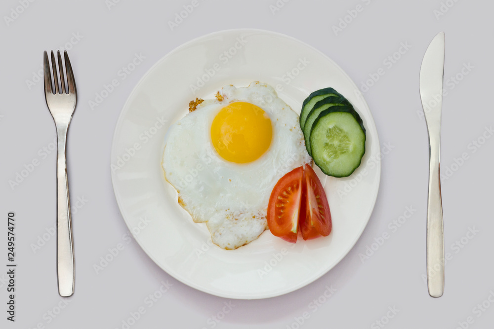 tasty and healthy breakfast of fried eggs, slices of cucumber and tomato slices tasty and healthy breakfast of fried eggs, slices of cucumber and tomato slices