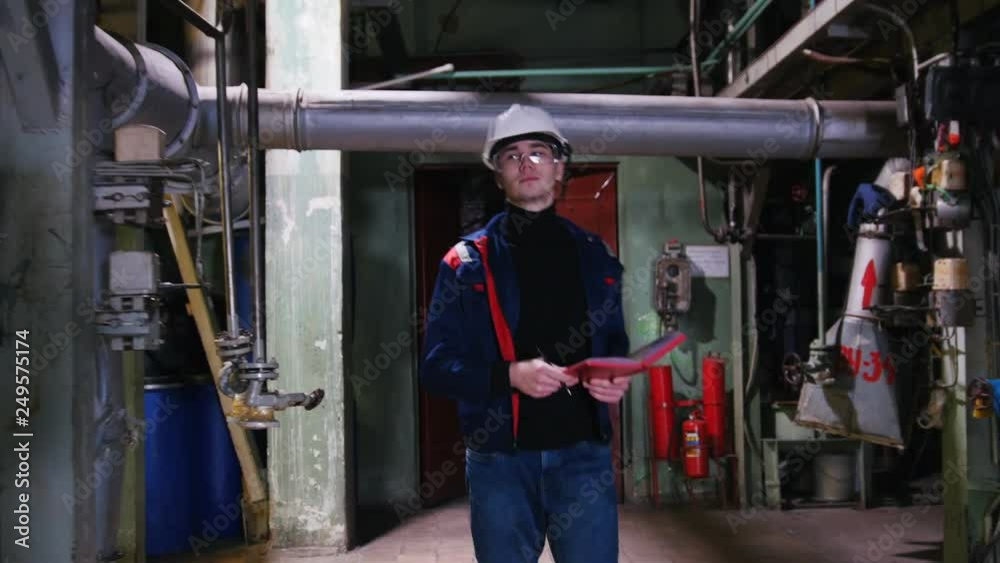 A man engineer walking in manufacturing plant A man engineer walking in manufacturing plant