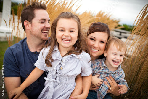 Happy Young Family Laughing Together Outside