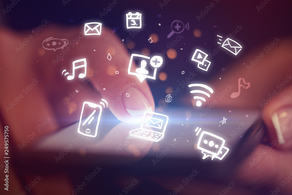Fototapeta premium Finger touching phone with hologram application icons and dark background