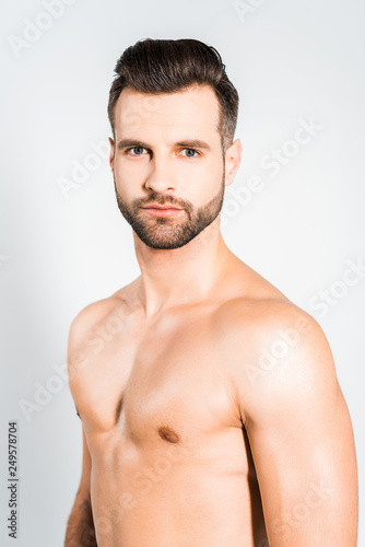 handsome bearded man posing isolated on grey