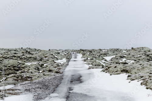 Frozen road through moss lava fields, Iceland