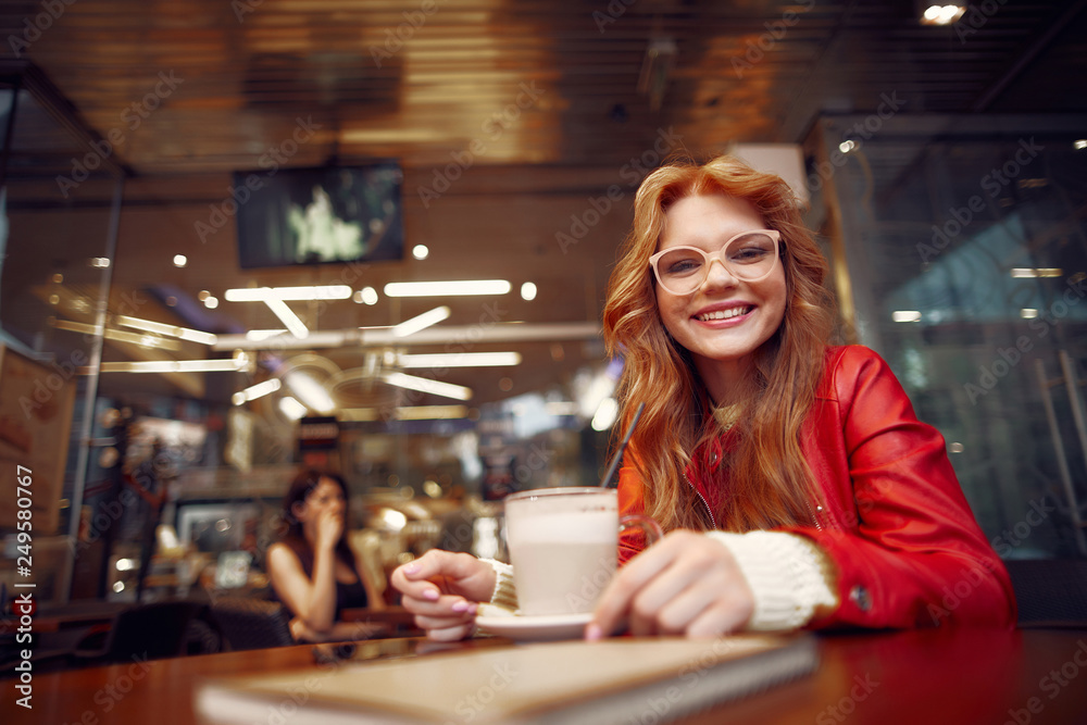 Charming young lady in glasses spending time in cafe Charming young lady in glasses spending time in cafe