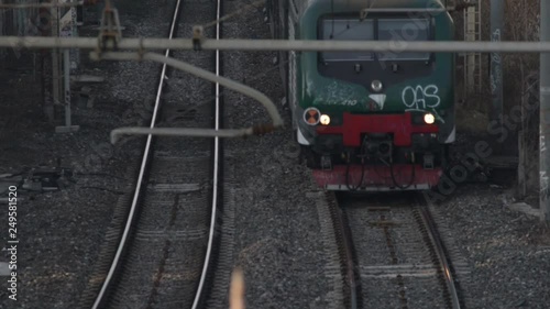 passenger train transits on the line with cables and pylons