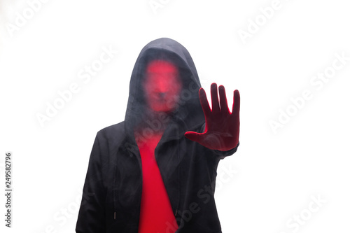 Red man in a black hood and smoke showing stop sign. Isolated on white