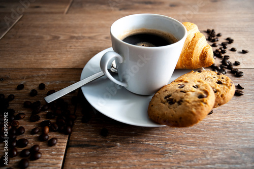 coffee in white mug with cookies and Croissant photo