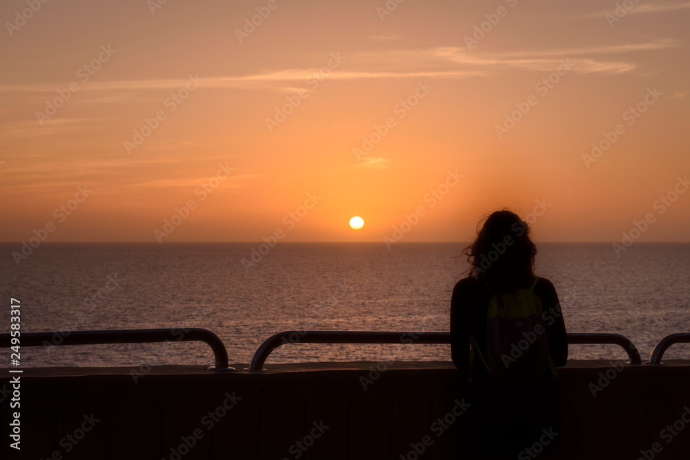 woman silhouette against sunset