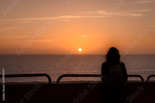 woman silhouette against sunset
