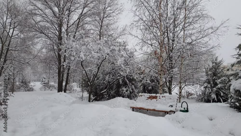 City park and bench during a snowfall in Moscow, Russia City park and bench during a snowfall in Moscow, Russia